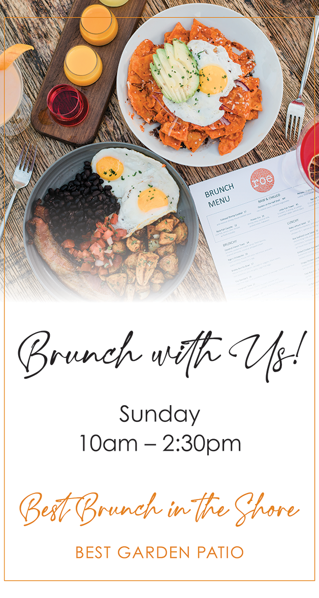 Two brunch plates with eggs and avocado, menu, and drinks on a table. Brunch Sunday 10am–2:30pm.