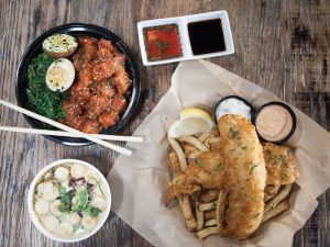 Overhead shot of fish and chips, poke and scallops all in separate bowls