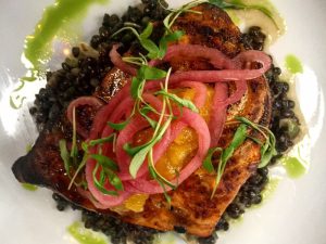 overhead view of grilled salmon with red onions