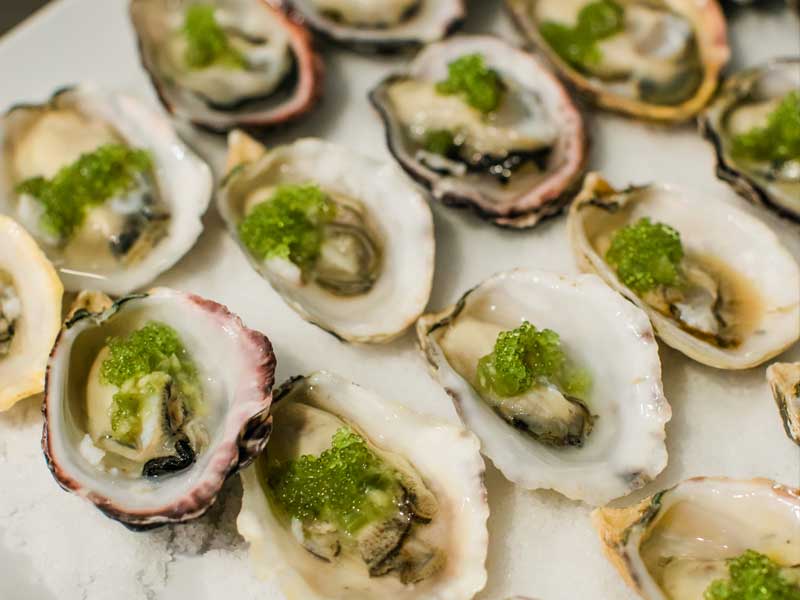raw oysters on a half shell topped with caviar